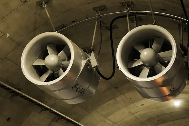 Twin industrial jet axial fans suspended from a basement ceiling layout for parking or tunnel ventilation