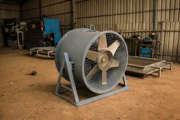 Industrial axial man cooler fan mounted on a heavy floor-standing triangular steel support frame