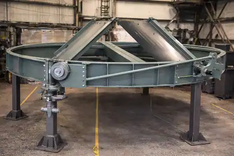 Heavy industrial stack or diverter damper system with a triangular metal framing structure resting on supports